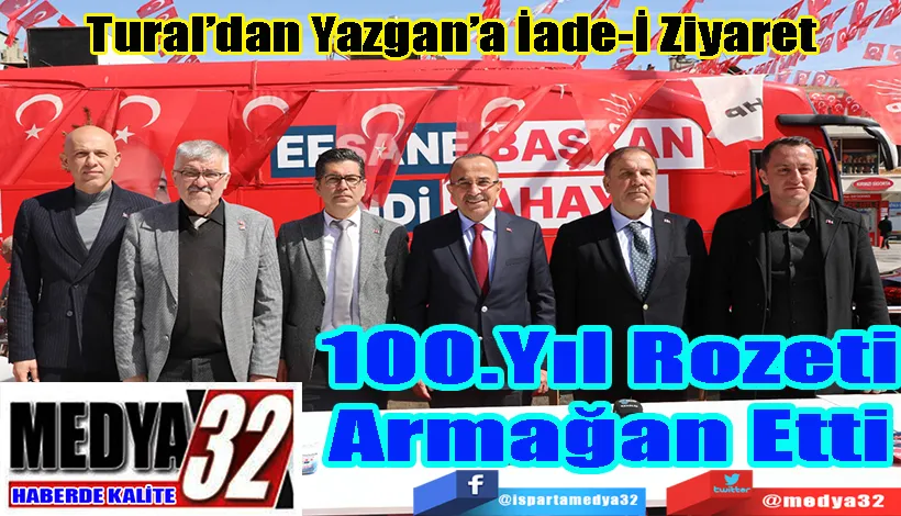 Tural’dan Yazgan’a İade-İ Ziyaret 100.Yıl Rozeti Armağan Etti